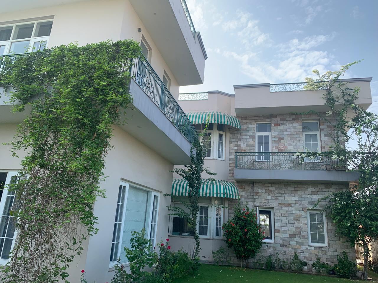Front of the house with green awnings